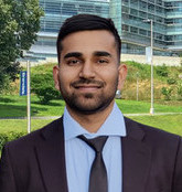 dorababu bandi smiling standing with brandeis stone in the background