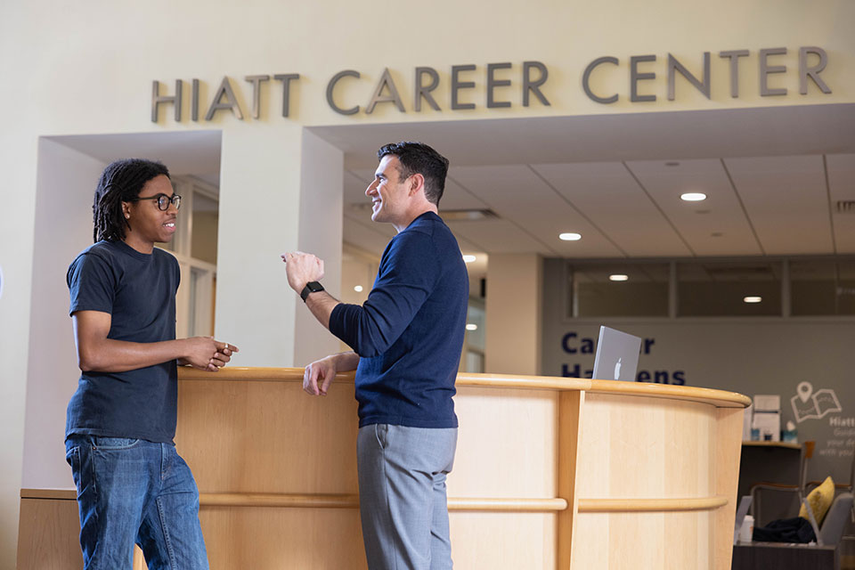 A student speaks with a staff member at the Hiatt Career center.