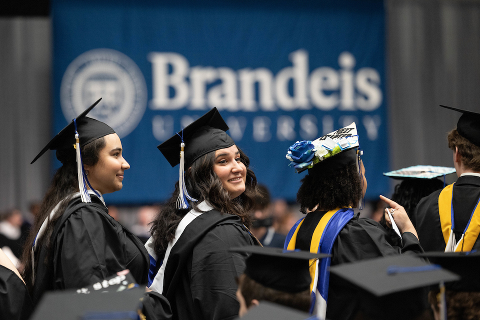 Students prepare to walk the stage at the Gosman Sports and Convocation Center during Commencement at Brandeis University on May 20, 2023.