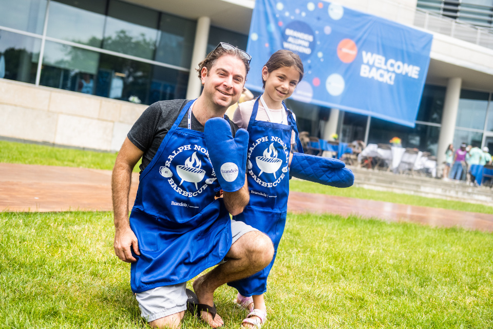 father and daughter at the ralph norman bbq wearing apron and oven mitts