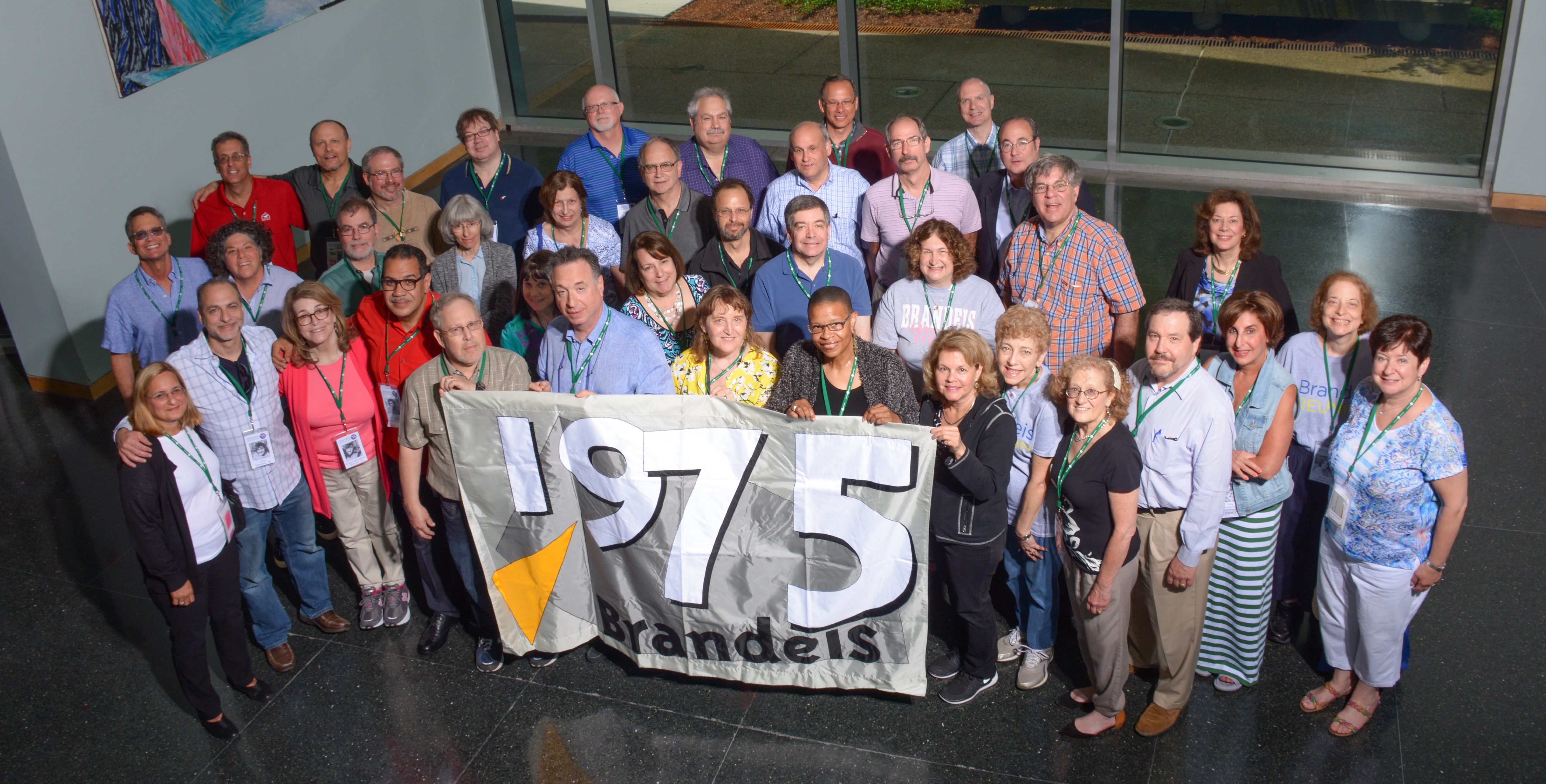 Class photo with class members standing in rows holding the class flag