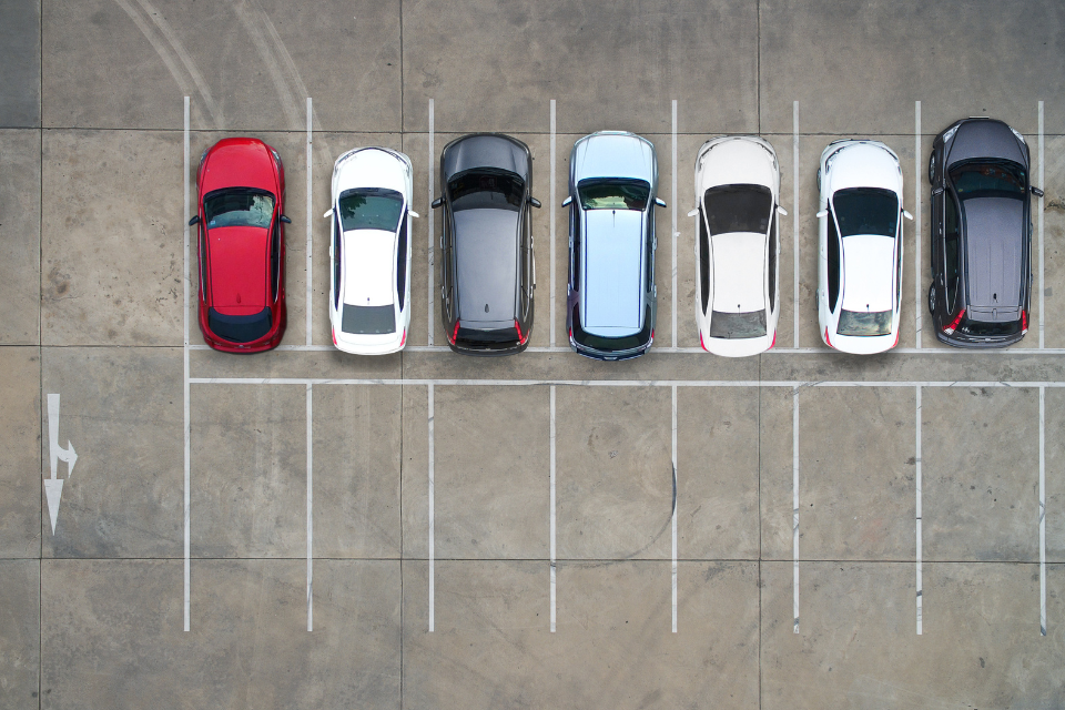 seven cars parked in an empty lot