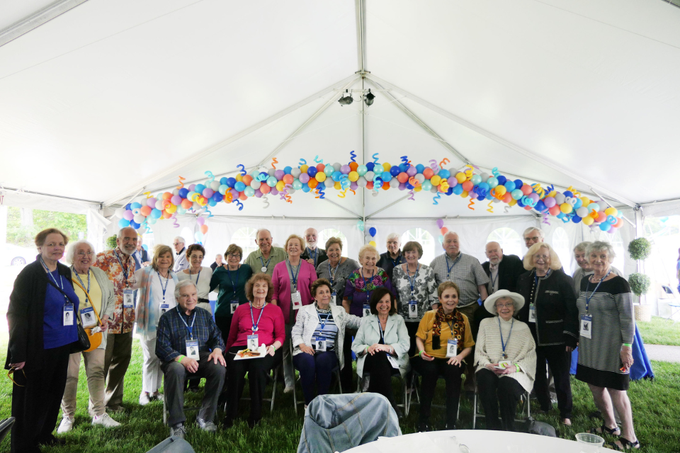 group of alumni from class of 1959 gathered under tent