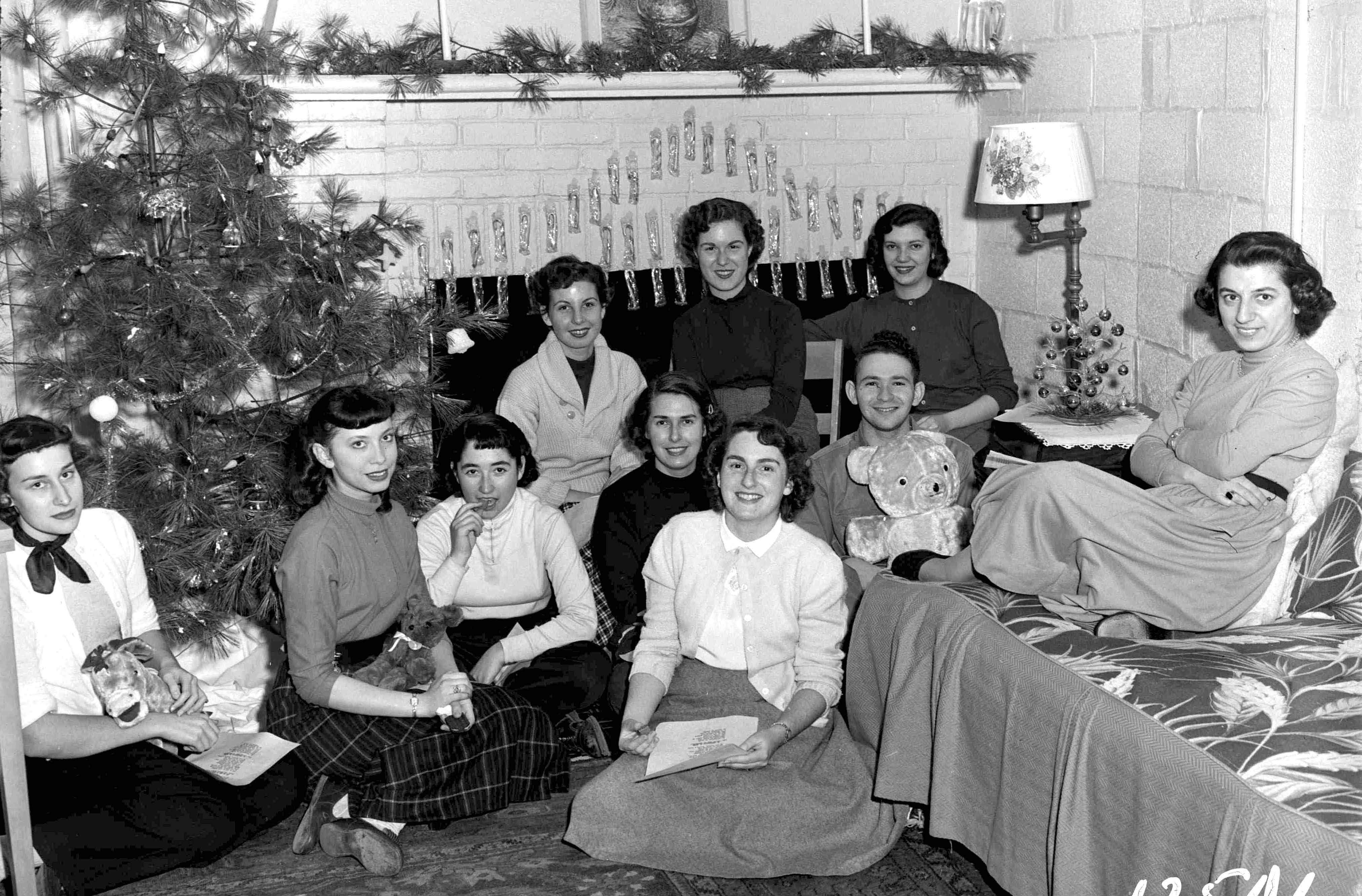 Group of female students in a living room decorated for the holidays.