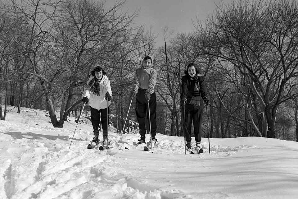 Three female students cross-country skiing 
