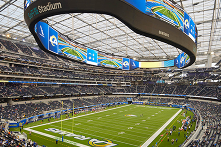 image of hands holding a phone taking a group photo at alumni weekend