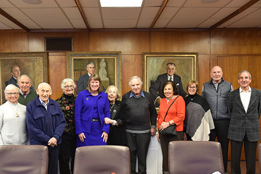 a group of Sachar Legacy Society members with Provost Lisa Lynch in board room