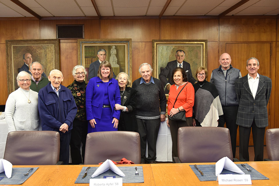 Sachar Legacy Society members in front of paintings in board room