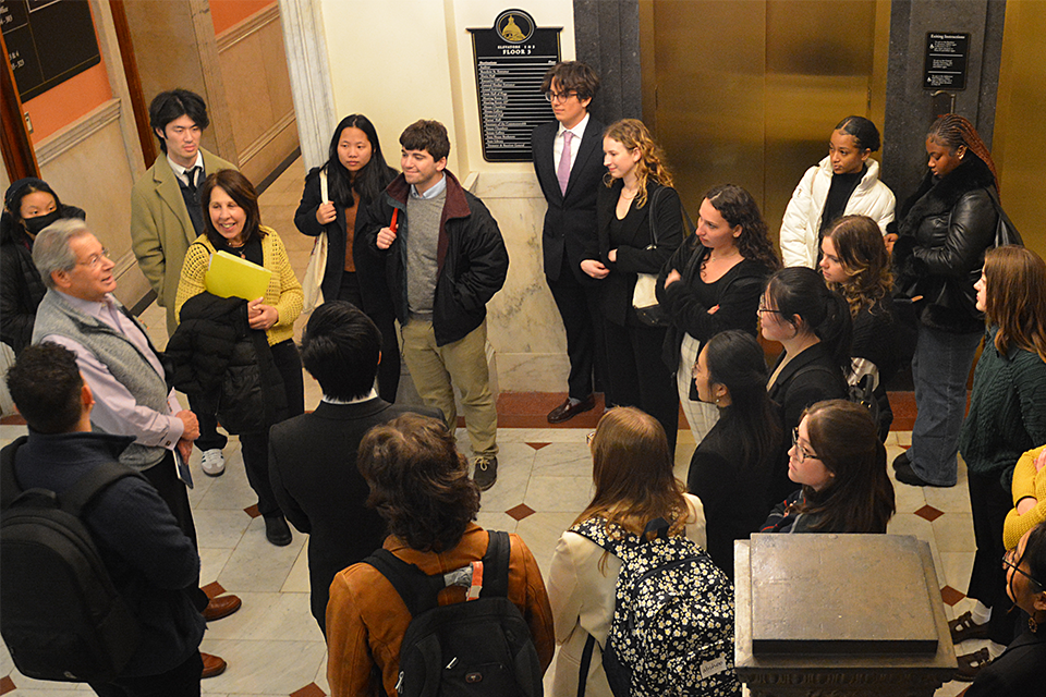 Students are at the State House being given a tour by Former Mass. State Rep. Jay Kaufman  ’68, MA’73, Distinguished Legislative Mentor for ENACT