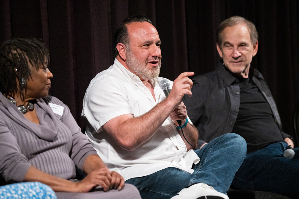 A man speaks into a microphone.