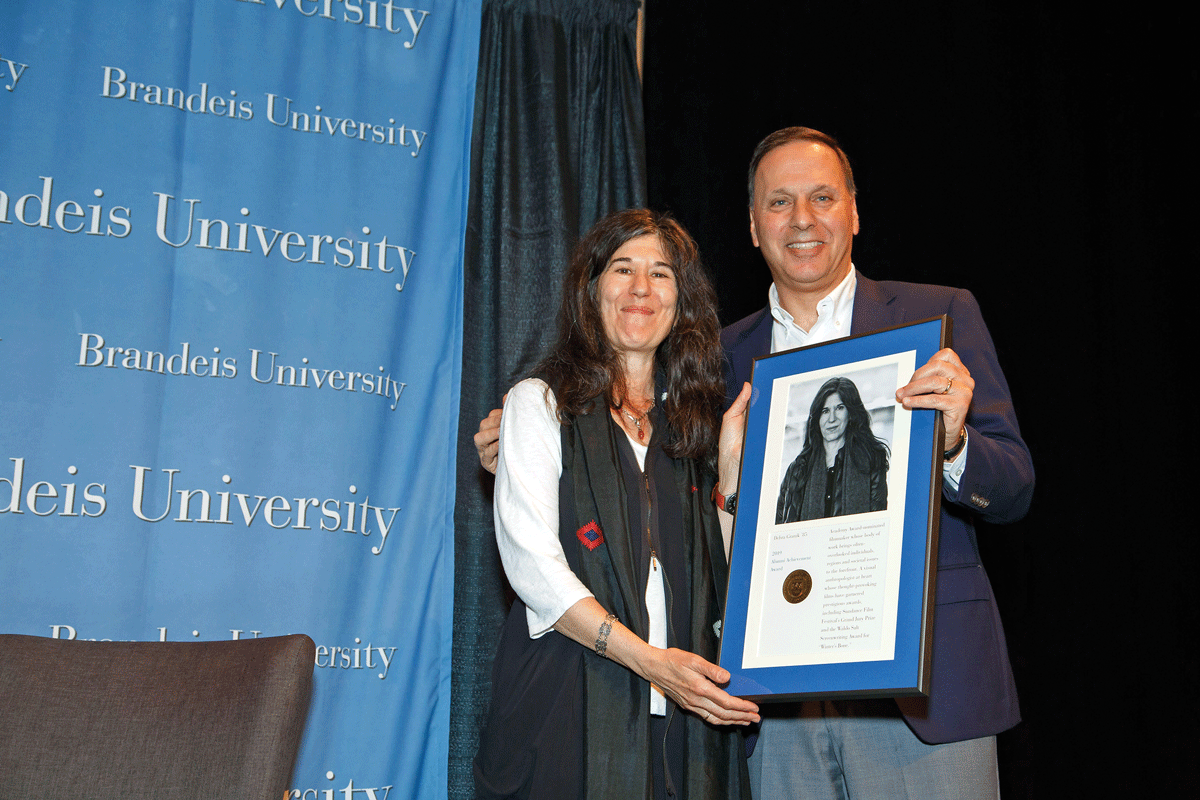 President Ron Liebowitz presenting filmmaker Debra Granik with 2019 Alumni Achievement Award 