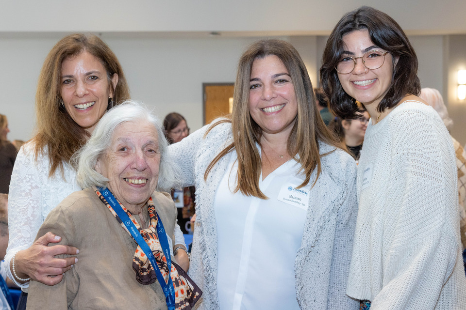 Family members of various ages smiling and posing for a photo.