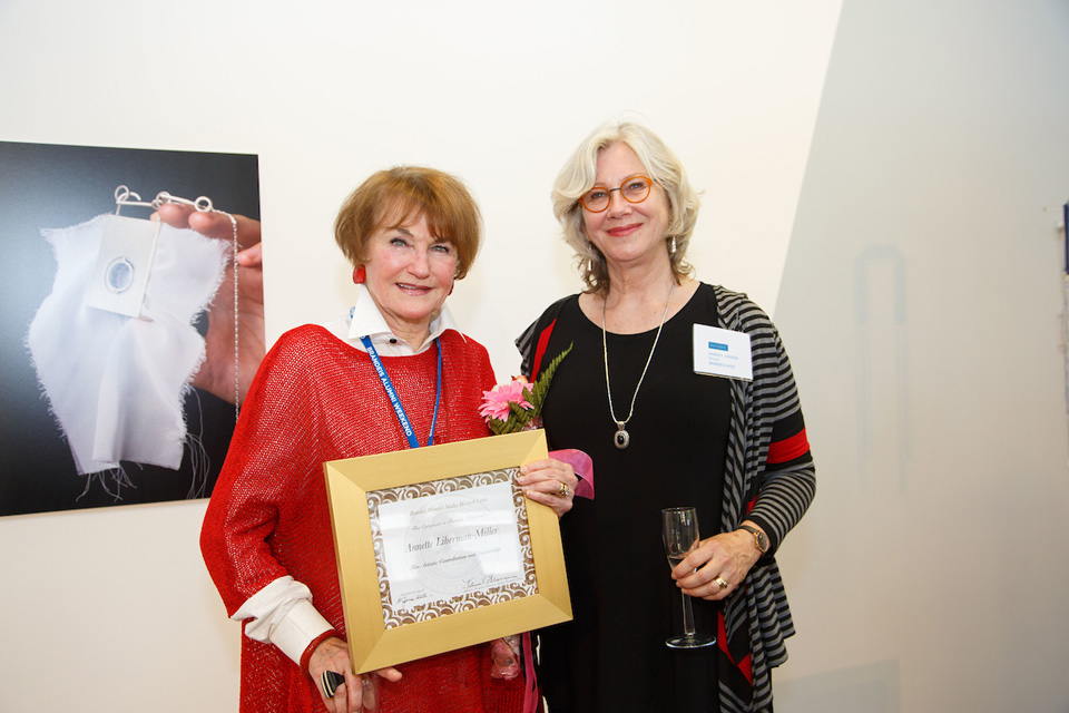 Woman receive a plaque at the Rose Art Museam