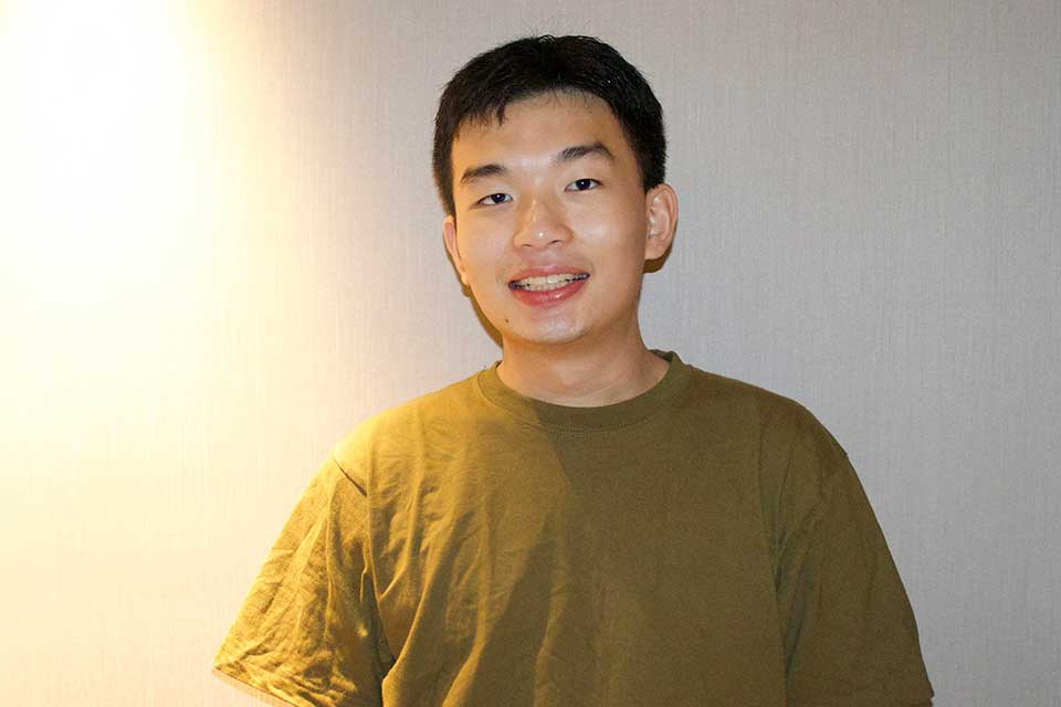 Frank Zhang smiling at the camera