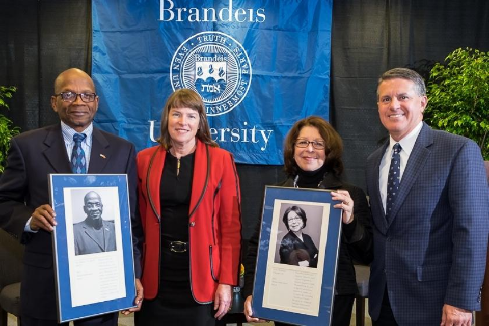 Left to right: Roy Berry holding Alumni Achievement award, Interim President Lisa Lynch, Susan Weildman Schneider holding Alumni Achievement Award, and Perry Traquina, chair of the Board of Trustees