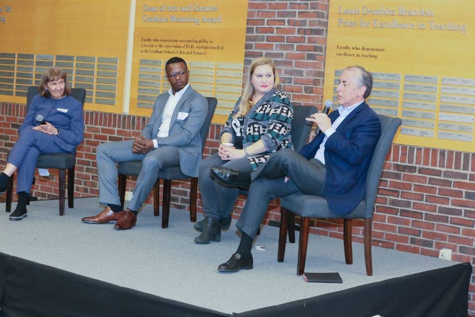 A panel of speakers addresses an audience in the Usdan Student Center