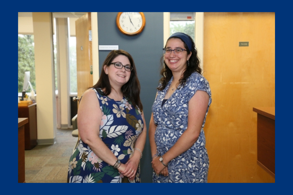 From left to right, Caroline Cadel and Lea Winkler smile at the camera in a bright office setting