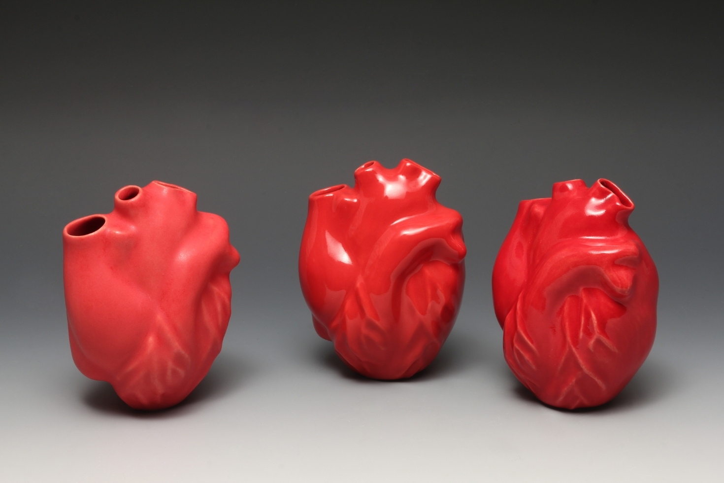 Three ceramic red hearts