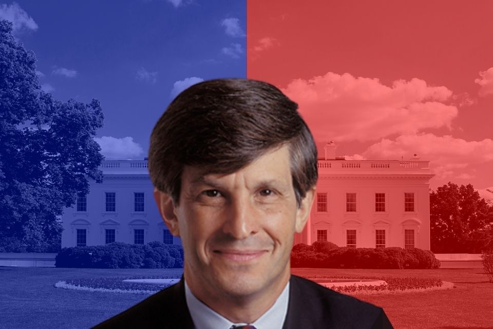Allan Lichtman in front of a graphic of the white house with blue on the left and red on the right