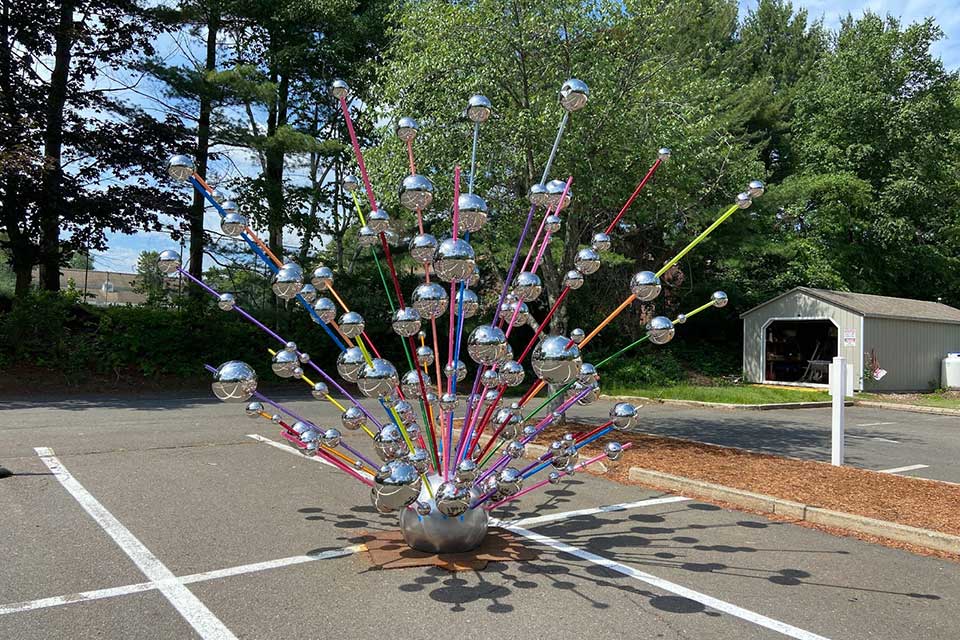 Sculpture "Mishegas" with metallic spheres atop  multi-colored rods.