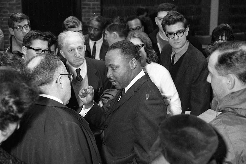 Dr. King speaking among a crowd at Brandeis in 1963