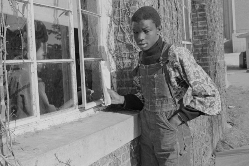 Reggie Sapp looking into a window at another student during the takeover of Ford Hall. 