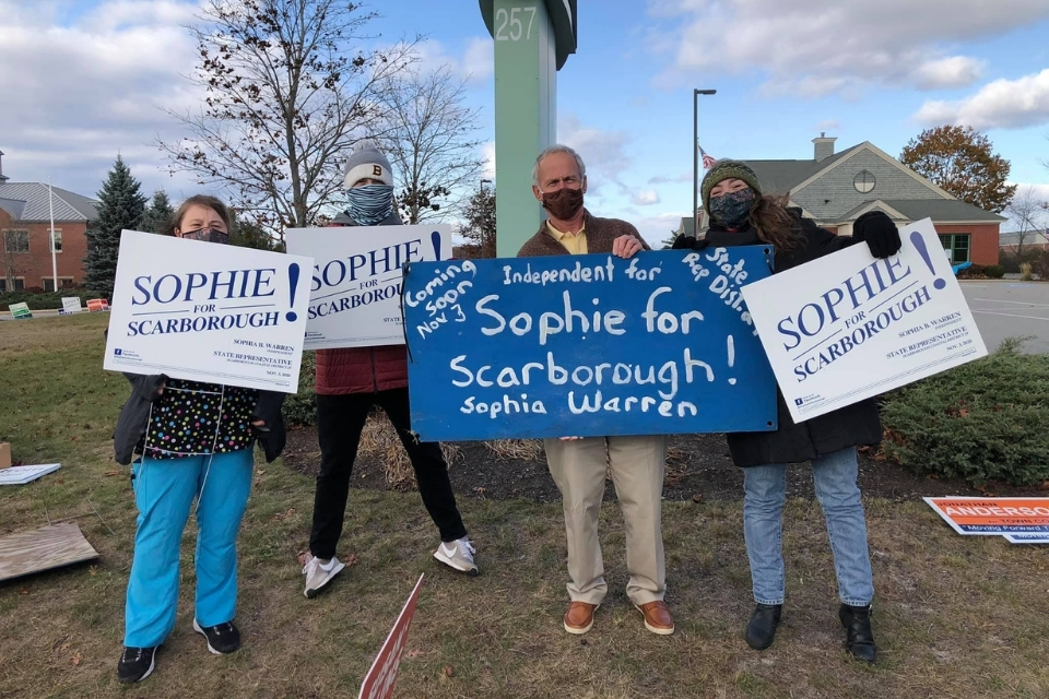 Sophia Warren and supporters holding signs.