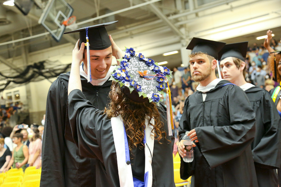 Students fix their caps in preparation for a picture perfect ceremony. 