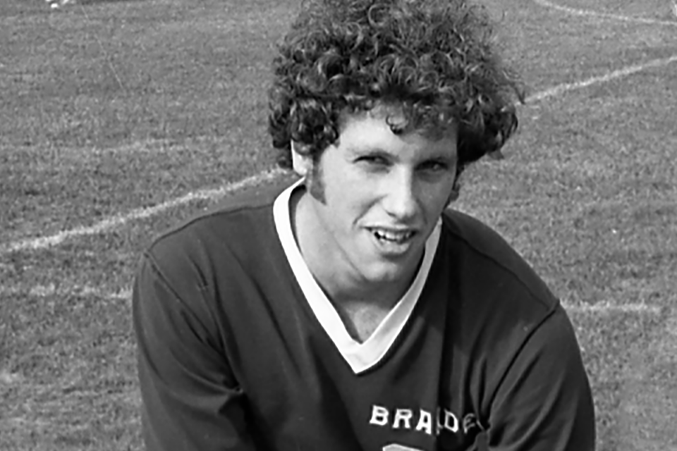 A black and white photo of Barry Harsip on a soccer field.