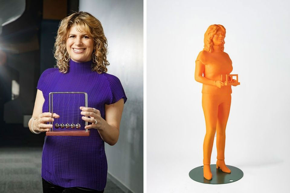 Deborah Berebichez holding a ? on the left. Her 3-D printed statue on the right. 