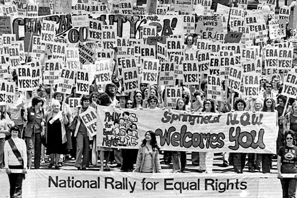Crowd of people holding ERA signs 