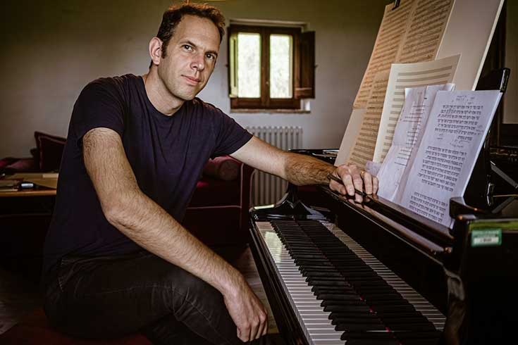 Yotam Haber sitting at the piano. 