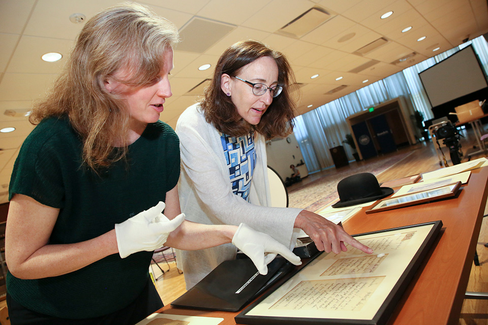 Louisa Brandeis Popkin with Sarah Shoemaker, looking at donated artifacts.