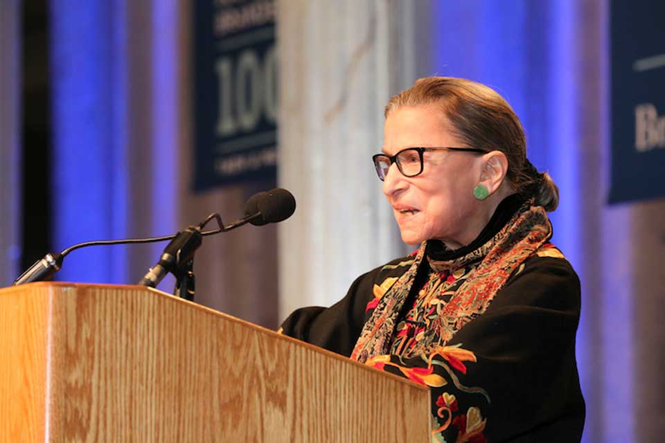 Ruth Bader Ginsburg standing at a podium at Brandeis University