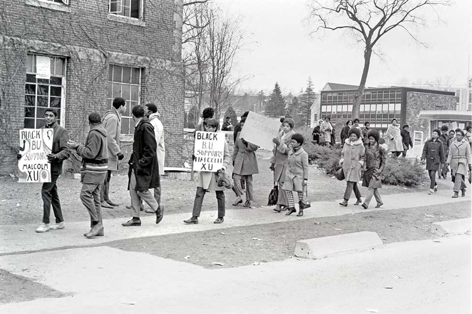 Black students holding signs and protesting at Brandeis in 1969