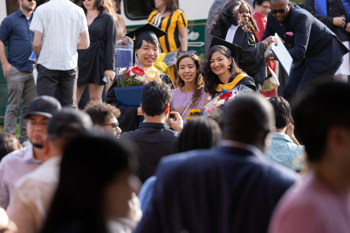 Friends and family step outside to capture photos with the graduates.