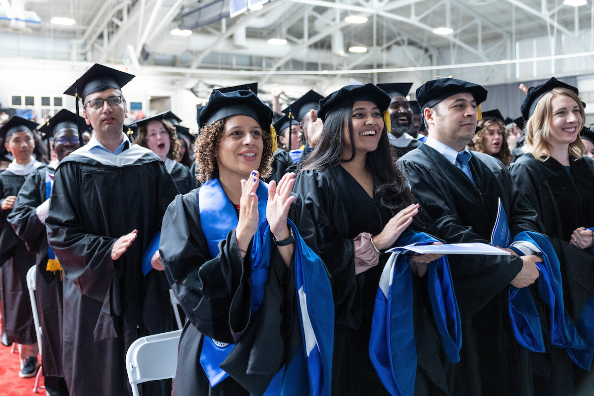 Graduates of the Heller School for Social Policy and Management cheer for their peers.