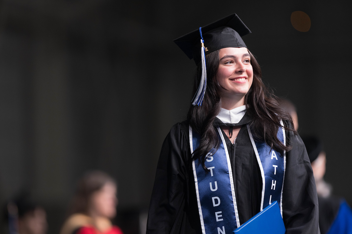 Monica Isabel Aponte Rodríguez ’23 smiles to the crowd as she walks the stage.
