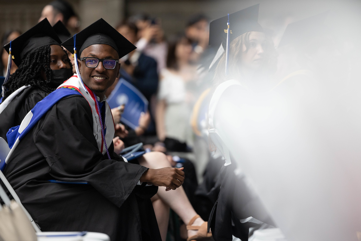 Xavier Butler ’23 looks on as classmates make their way to the stage.