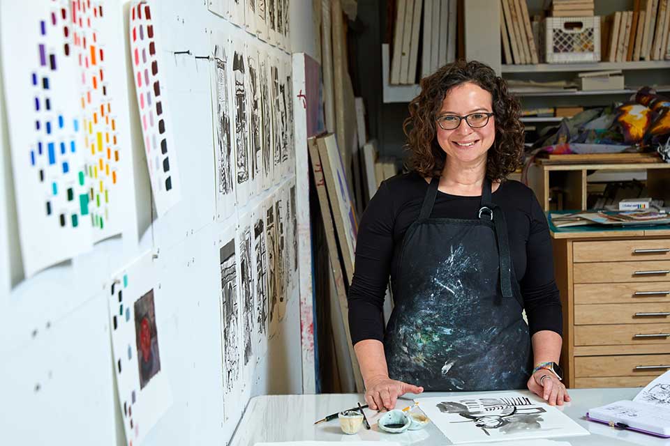 Alison Judd smiling while standing in an art studio