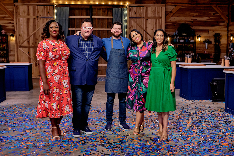 2011 Brandeis graduate Brad Mahlof celebrates his victory with the show's judges.