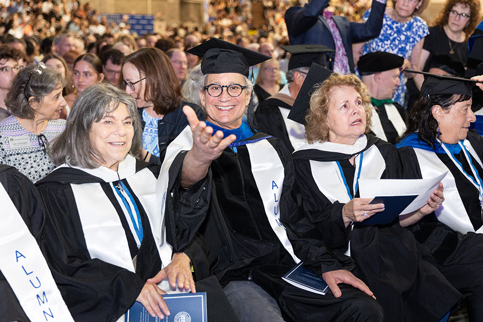 Alumni in the Class of 1975 sitting in the audience at Commencement.