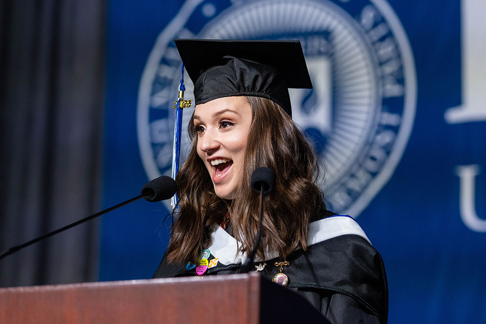 Hana Klempnauer Miller delivers remarks at a podium.