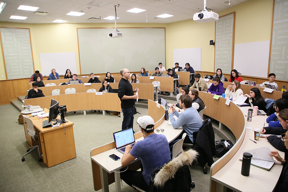 Professor teaching students in a Brandeis classroom