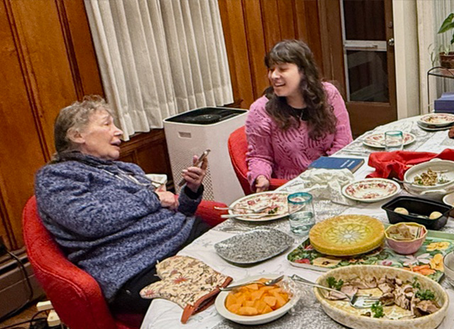 Lilly and Max's wife at dinner