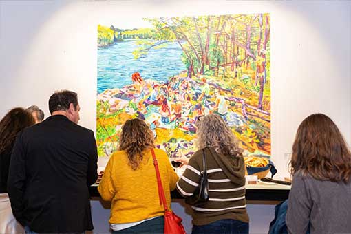 A crowd enjoys the art