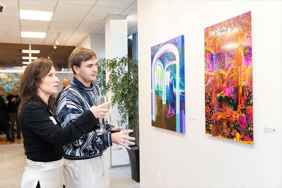 Alumni enjoying the art at the alumni art gallery