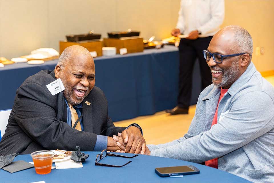 Alumni laughing together