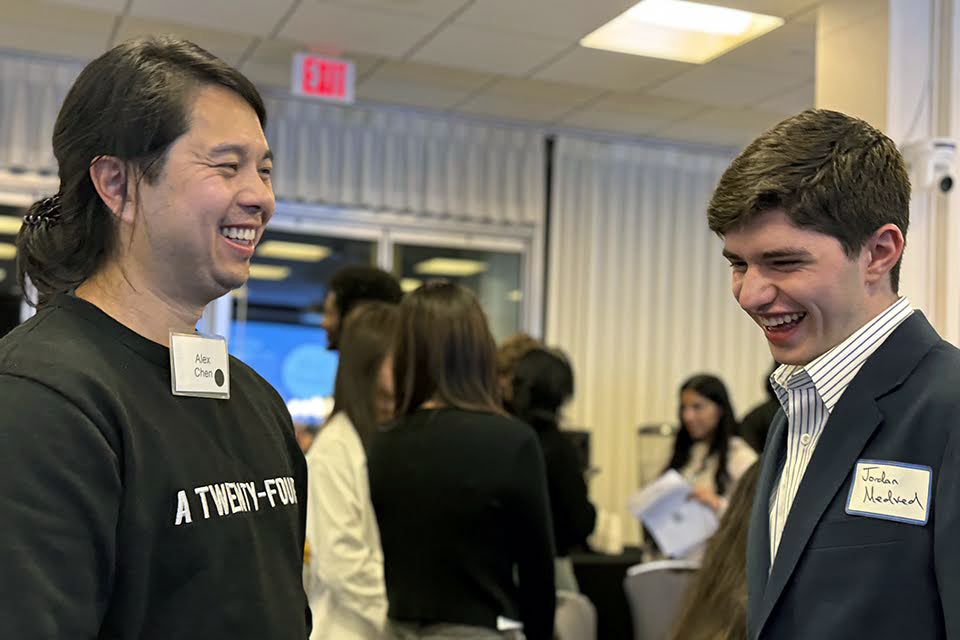 An alum and current student share a moment of laughter together at the 4th annual DEIS Dinner.