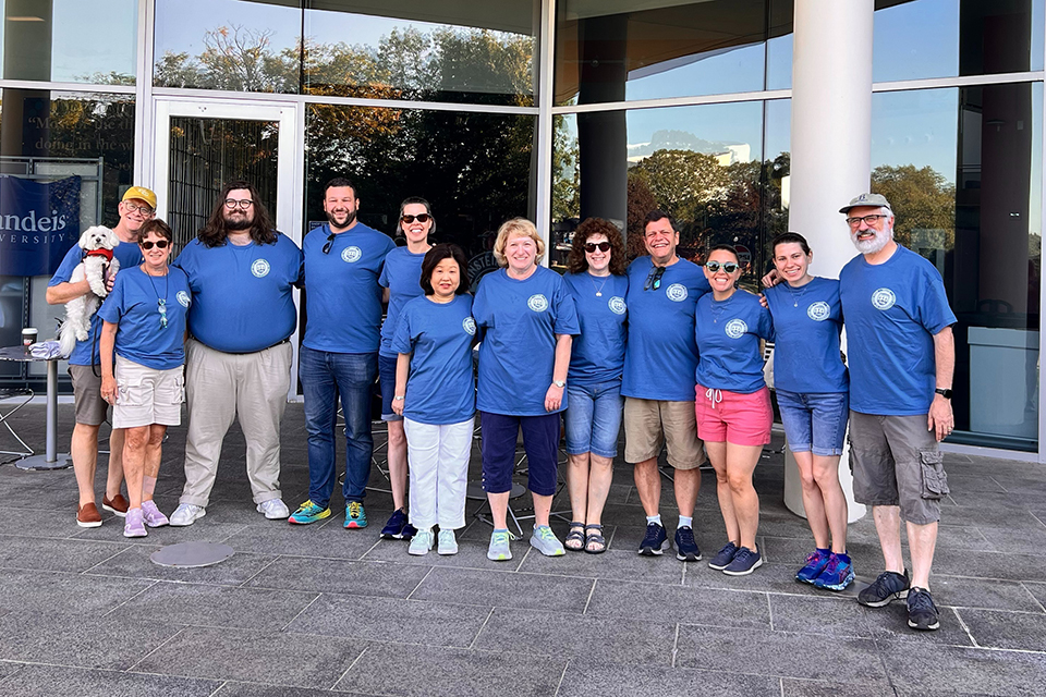 Group of alumni volunteers in blue shirts